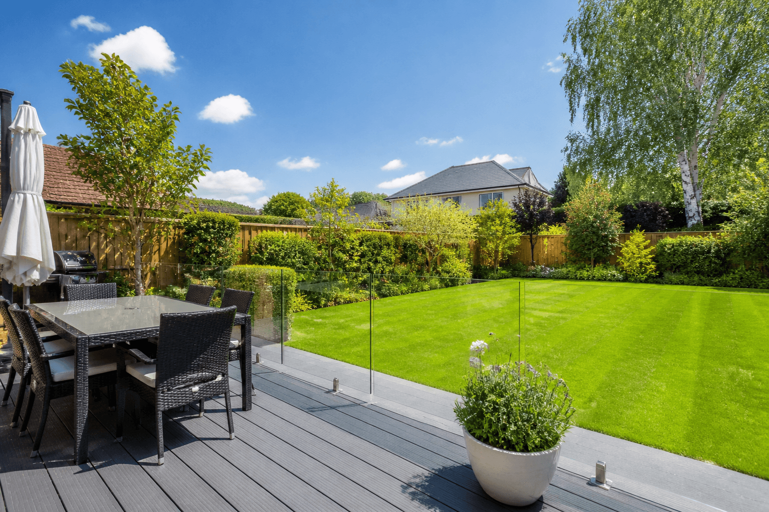 Modern grey composite decking with glass balustrade
